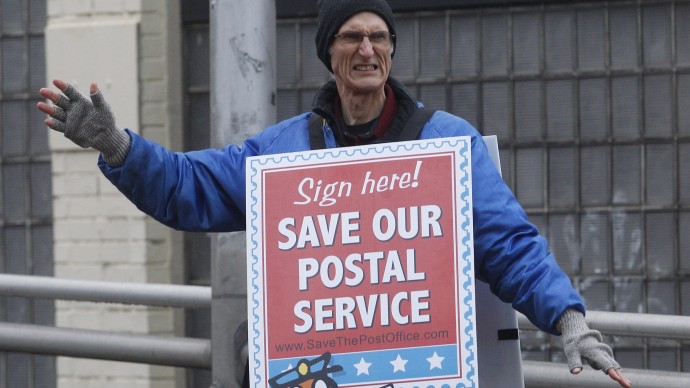 Jamie Partridge, from the National Association of Letter Carriers, protests Wednesday, Nov. 30, 2011, in, Portland, Ore. Partridge was one of the postal workers participating in a hunger strike to protest Congress' inaction of aiding the Postal Service. (AP Photo/Rick Bowmer)