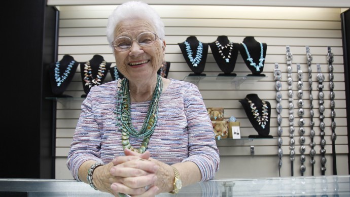 In this photo made Wednesday, Oct. 19, 2011, Maxine Bennett, 91, smiles at a counter at her jewelry store in Dallas. Bennett is part of a growing number of people who continue working way past the usual retirement age. (AP Photo/LM Otero)