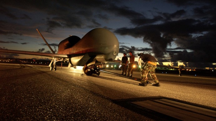 A flightline ground crew secures an unmanned aerial vehicle for towing to a secure hanger. (U.S. Air Force photo by Senior Airman Miranda Moorer)
