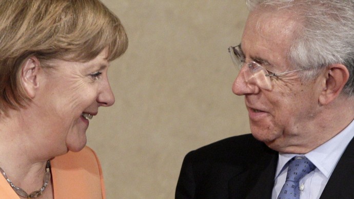 In this July 4, 2012 file picture German Chancellor Angela Merkel, left, talks with Italian Premier Mario Monti during a bilateral meeting at Villa Madama in Rome. (AP Photo/Riccardo De Luca, File)