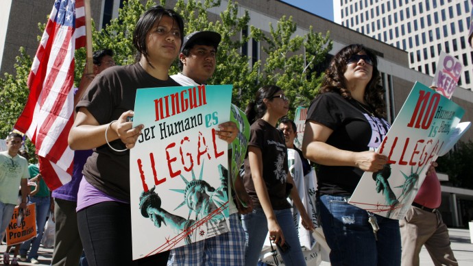 In this Tuesday, June 15, 2010 file photo, immigration reform advocates march around the Federal Courthouse in downtown Denver. (AP Photo/David Zalubowski)