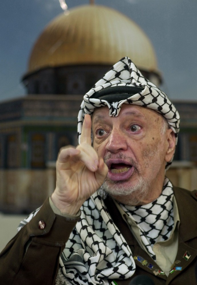 In this Dec. 24, 2002 file photo, Palestinian leader Yasser Arafat talks to the media during a press conference at his headquarters, in the West Bank town of Ramallah. (AP Photo/Muhammed Muheisen, File)