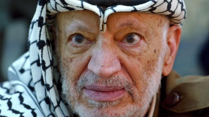 In this Saturday, Oct. 2, 2004 file photo, Palestinian leader Yasser Arafat pauses during an emergency cabinet session, at his compound, in the West Bank town of Ramallah. Yasser Arafat's body may be exhumed to allow for more testing of the causes of his death, the Palestinian president said Wednesday, July 4, 2012, after a Swiss lab said it found elevated levels of a radioactive isotope in belongings the Palestinian leader is said to have used in his final days.(AP Photo/Muhammed Muheisen, File)