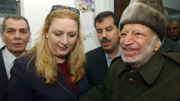 In this Friday, Oct. 29, 2004 file photo, Palestinian leader Yasser Arafat and his wife Suha hold hands prior to Arafat's departure from his compound in the West Bank town of Ramallah in this file picture released by the Palestinian Authority. (AP Photo/Palestinian Authority, Hussein Hussein, File)