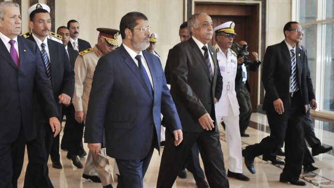 In this photo released by Middle East News Agency, the Egyptian official news agency, President-elect Mohammed Morsi, front left, is accompanied by Interior Minister Mohammed Ibrahim, third left, in Cairo, Egypt, Tuesday, June 26, 2012. (AP Photo/Middle East News Agency, HO)