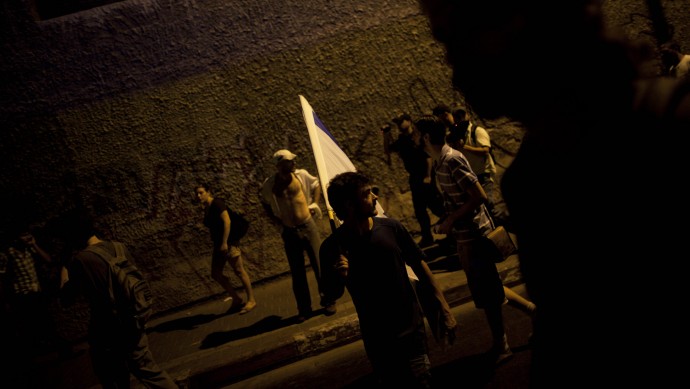 Israelis block a highway in Tel Aviv on  Sunday, July 15, 2012, during a protest against the economic policies of Israel's government and to show solidarity with Moshe Silman. (AP Photo/Oded Balilty)