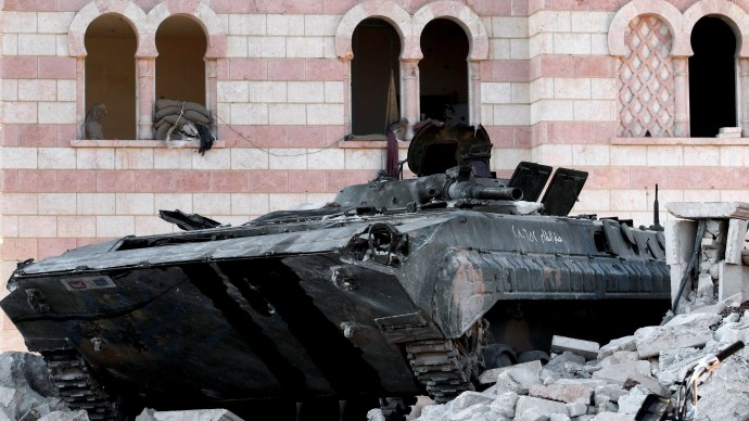 In this Tuesday, July 24, 2012 photo, a damaged Syrian military tank is seen at the border town of Azaz, some 20 miles (32 kilometers) north of Aleppo, Syria. Turkey sealed its border with Syria to trucks on Wednesday, July 25, 2012 cutting off a vital supply line to the embattled nation as fighting stretched into its fifth day in the commercial capital of Aleppo. (AP Photo/Turkpix)