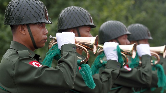 Myanmar soldiers play wind pipes during the ceremony to mark 65th anniversary Martyrs Day at Mausoleum on Thursday, July.19, 2012, in Yangon, Myanmar. (AP Photo/Khin Maung Win)