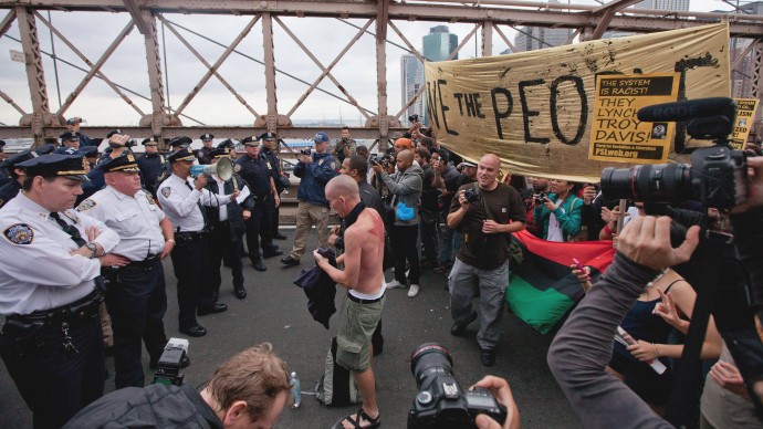 In this Oct. 1, 2011 a line of police officers block protesters on New York's Brooklyn Bridge during a march by Occupy Wall Street. A judge said in a ruling released Monday, July 2, 2012 that Twitter must give a court almost three months' worth of an Occupy Wall Street protester's tweets after prosecutors demand the messages to make a case for arrests. (AP Photo/Will Stevens, File)
