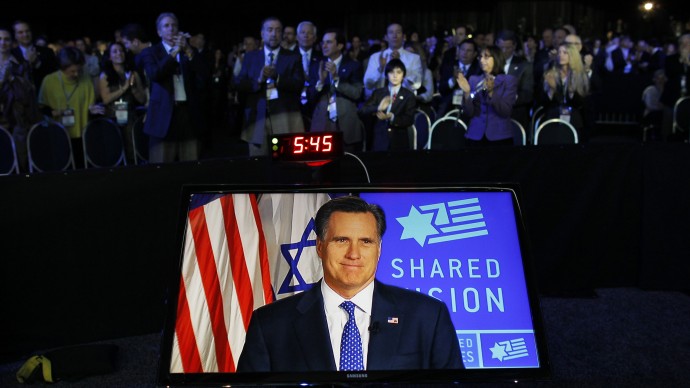 In this March 6, 2012, file photo, Republican presidential candidate, former Massachusetts Gov. Mitt Romney, is displayed on screen as he speaks before the American Israel Public Affairs Committee (AIPAC), via satellite in Washington. (AP Photo/Charles Dharapak, File)