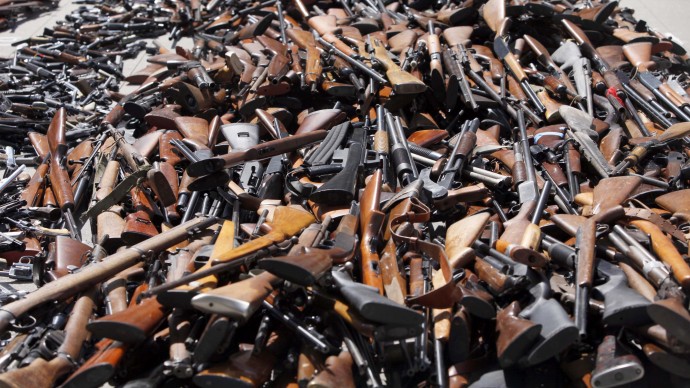 A pile of guns are displayed at a news conference after an annual Gun Buyback Program at the Los Angeles Police headquarters in Los Angeles on Monday, May 14, 2012. Chicago hosted a similar program Saturday, June 23, 2012, with money from the collected guns going to an NRA youth camp.(AP Photo/Nick Ut)