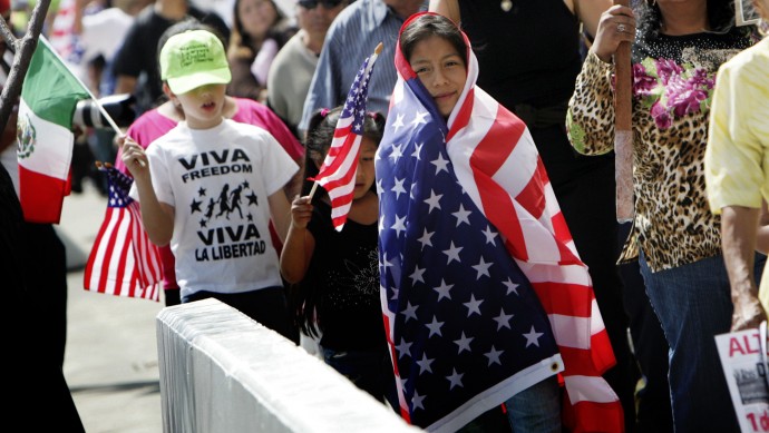 Leticia Tepetitla, 9, wearing a U.S. flag, marches with other demonstrators calling for immigration reform. (AP Photo/Stefano Paltera)