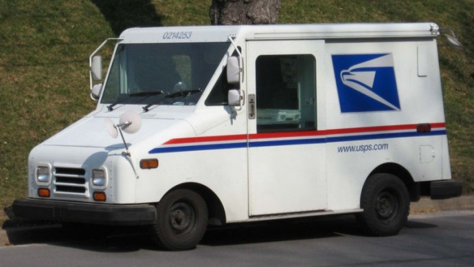 A United States Postal Service mail truck carries mail July 8, 2012. (Photo by David Guo via Flikr)