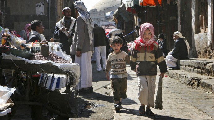 Two children walk along a market street in the capital San'a, Yemen, Dec. 3, 2008. Even in Yemen's breadbasket, people are having trouble feeding themselves in what food experts say is a hidden but growing hunger problem across this impoverished country, the poorest in the Middle East, that could push it to collapse. (AP Photo/Paul Schemm)