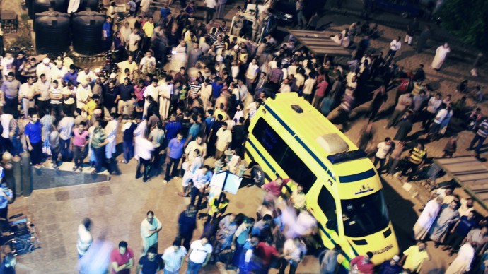 In this Sunday, Aug. 5, 2012 photo, Egyptians stand outside the El Arish hospital. (AP Photo)