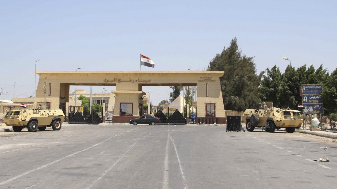 In this Monday Aug. 6, 2012 file photograph, the Rafah border terminal between Egypt and Gaza, and the only gateway for Gaza's people, is closed and guarded by Egyptian border guards in Rafah, Egypt. (AP Photo/Ahmed Gomaa, File)