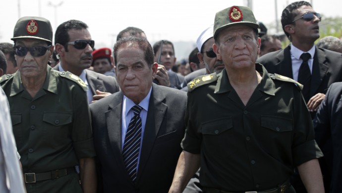 Defense Minister Hussein Tantawi, left, former Prime Minister Kamal Ganzouri, center and Armed Forces Chief of Staff Sami Anan, attend the funeral of 16 soldiers killed in an attack over the weekend by suspected militants in Sinai in Cairo, Egypt , Tuesday Aug. 7, 2012. (AP Photo/Thomas Hartwell)
