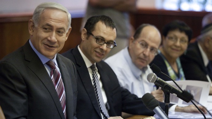 Israeli Prime Minister Benjamin Netanyahu, left, chairs the weekly cabinet meeting at the Prime Minister's Office in Jerusalem, Sunday, Aug. 12, 2012. (AP Photo/Abir Sultan, Pool)