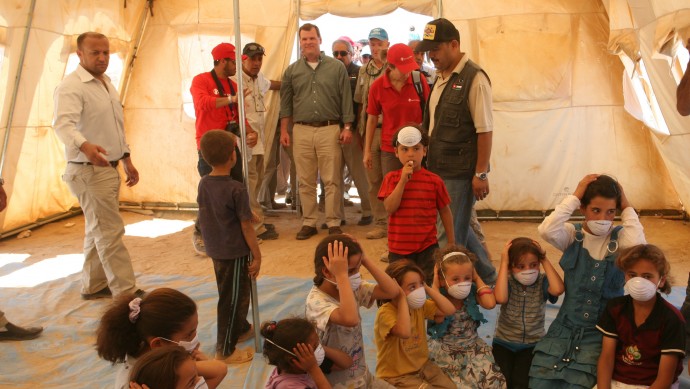 Canadian Foreign Affairs Minister John Baird, center, stops by UNICEF classroom tent during his tour at Zaatari camp for Syrian refugees in Mafraq, Jordan, Saturday, Aug. 11, 2012. (AP photo/Mohammad Hannon)