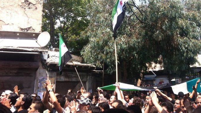 In this citizen journalism image provided by Shaam News Network SNN, taken on Wednesday, Aug. 1, 2012, Syrians chant slogans during a demonstration in Damascus, Syria. (AP Photo/Shaam News Network, SNN)