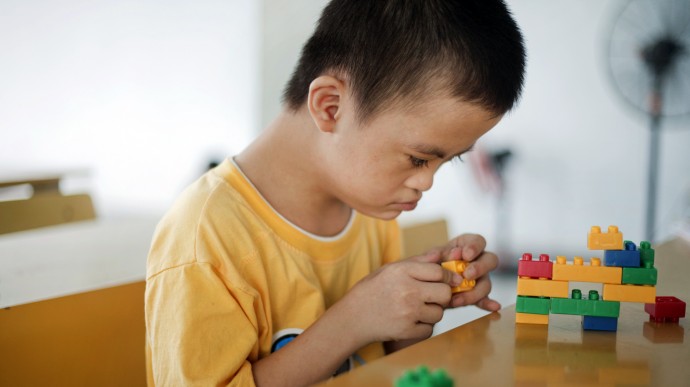 In this photo taken on Aug. 8, 2012, Le Trung Hong Phuc, 9, plays with colored blocks at a rehabilitation center in Danang, Vietnam. (Photo: Maika Elan / AP)