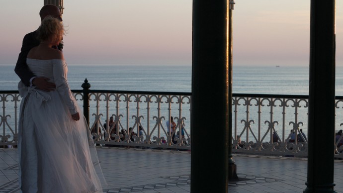A bride and groom stand at a bandstand on October 1, 2011. (Photo by Katie Lips via Flikr)