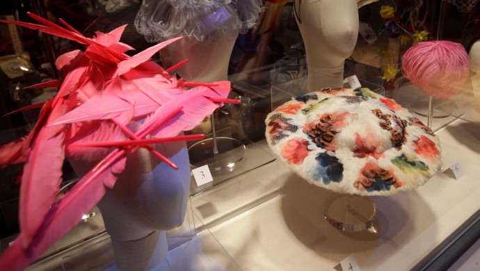 In this Thursday, Sept. 29, 2011 photo, fuchsia goose feathers adorn a 1995 hat by Philip Treacy, left, and guinea fowl feathers form the multi-colored pattern on a linen hat from 1700-1800 displayed in the exhibit "Hats: An Anthology by Stephen Jones," at the Bard Graduate Center in New York. (AP Photo/Kathy Willens)