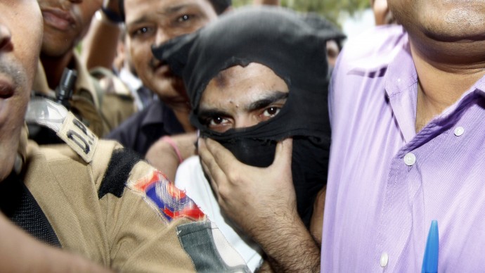 Security officers escort Sayed Zabiuddin Ansari, who also uses the alias Abu Jundal, a suspect in the 2008 Mumbai attacks arrested last month, outside a court in New Delhi, India, Friday, July 20, 2012. (AP Photo/Pankaj Nangia)