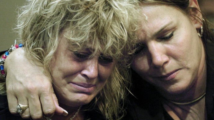 Susan Schorpen, mother of Carlie Brucia, weeps with Judy Cornett, right, as the guilty verdict is read for Joseph Smith at the Sarasota County Judicial Center in Sarasota, Fla., Thursday, Nov. 17, 2005. (AP Photo/Chip Litherland, File)