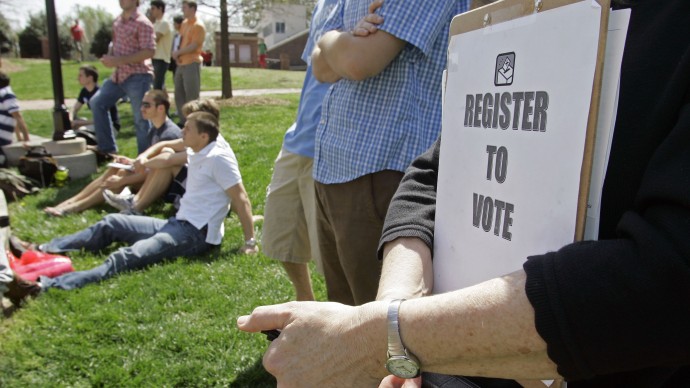 Mary Jo Clark holds a clipboard with forms for students to register to vote during a rally for Barack Obama at Davidson College in Davidson, N.C., Thursday, April 10, 2008. (AP Photo/Chuck Burton)