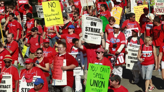 Striking Chicago school teachers march after a rally Saturday, Sept. 15, 2012 in Chicago. (AP Photo/Sitthixay Ditthavong)