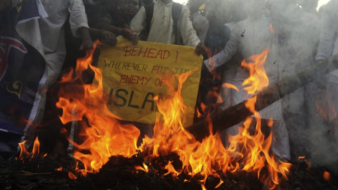 Indian Muslim students burn an effigy of U.S. President Barack Obama during a protest near the American Center in Kolkata, India, Wednesday, Sept. 19, 2012. The students were protesting against an anti-Islam film called "Innocence of Muslims" that ridicules Islam's Prophet Muhammad. (AP Photo)