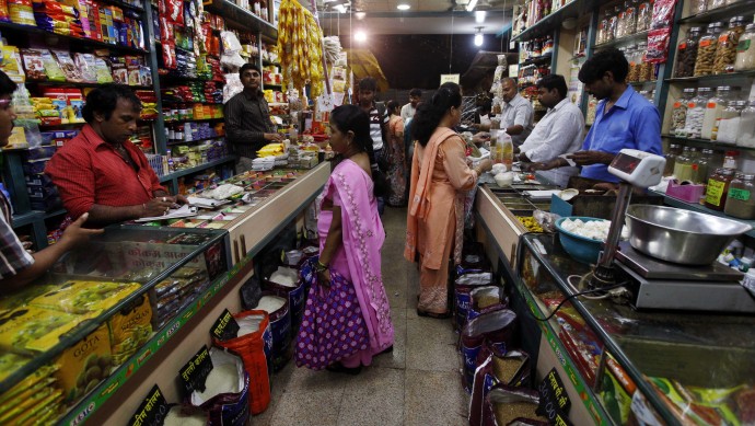 Indian people shop at a store in Mumbai, India, Friday, Sept. 14, 2012. India agreed Friday to open its huge market to foreign retailers such as Wal-Mart as part of a flurry of economic reforms aimed at sparking new growth in the country's sputtering economy. (AP Photo/Rajanish Kakade)