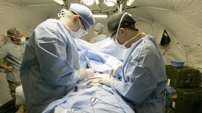 A surgical team performs surgery on a patient on Oct. 19, 2011. (Photo by Army Medicine via Flikr)
