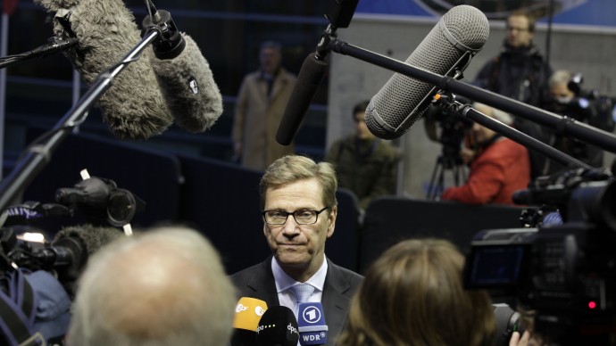German Foreign Minister Guido Westerwelle, center, speaks with the media as he arrives for a meeting of EU Foreign Ministers in Luxembourg on Monday Oct. 15, 2012. Britain, Germany and France say they expect the European Union to approve even tougher sanctions on Iran to prevent it from developing nuclear weapons. (AP Photo/Virginia Mayo)