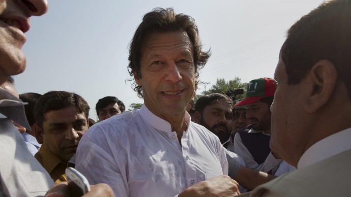 Pakistan's ex-cricket star-turned-politician Imran Khan, center, is surrounded by his supporters as he arrives to lead what organizers are calling the "peace march," in Islamabad, Pakistan, Saturday, Oct. 6, 2012. (AP Photo)