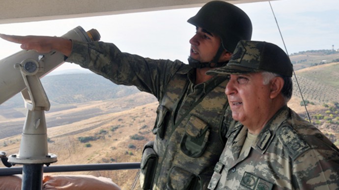 Turkish Chief of Staff Gen. Necdet Ozel, right, listens to a commander during his tour of the military along the border with Syria in Hatay, Turkey, Tuesday, Oct. 9, 2012. (AP Photo/Turkish Military, HO)