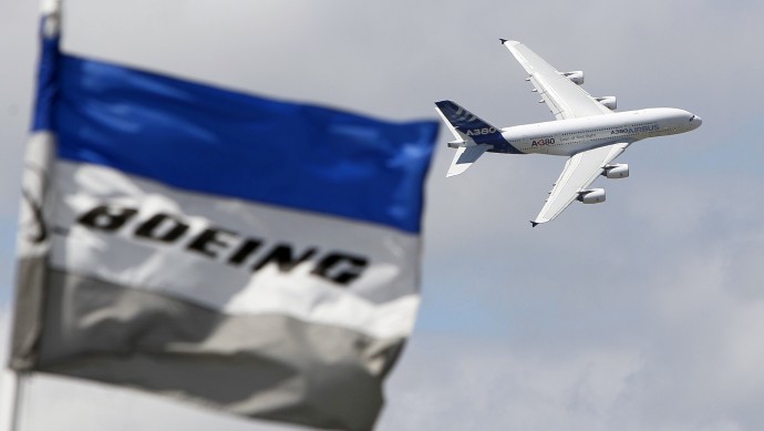 The June 25, 2011 file photo shows a Boeing flag fluttering as an Airbus A380 flies past during a demonstration flight at the 49th Paris Air Show at Le Bourget airport, east of Paris. (AP Photo/Francois Mori)