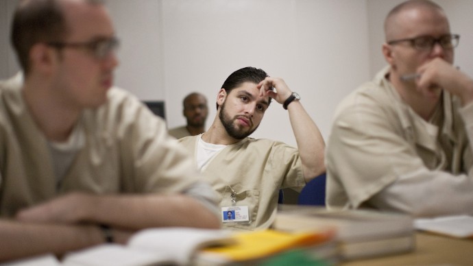 Michael Fauci, middle, Josh Hinman, left  Jason Peters, right listen to a lesson during a class at the Cheshire Correctional Institution in Cheshire, Conn., on Thursday, Jan. 28, 2010. (AP Photo/Thomas Cain)