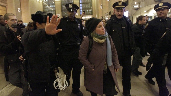 An Occupy Wall Street protester is escorted out of the main waiting area by police officers during a demonstration in New York's Grand Central Station, Tuesday, Jan. 3, 2012. About a hundred Occupy Wall Street protesters rallied in New York City's Grand Central Station to call attention to a law signed by President Barack Obama that they say represses civil liberties. Obama signed the National Defense Authorization Act into law on New Year's Eve. (AP Photo/Mary Altaffer)