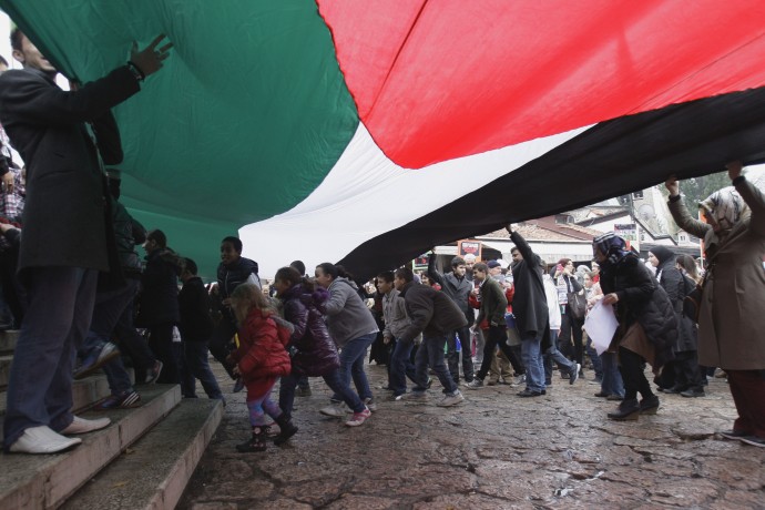 Bosnian supporters of Palestinians walk through the center of Sarajevo carrying Bosnian and Palestinian flags and pro-Palestinian banners in Sarajevo, Bosnia, on Tuesday, Nov. 20, 2012. (AP Photo/Amel Emric)