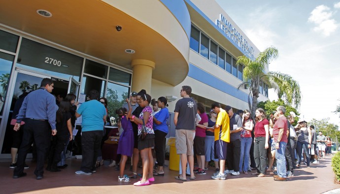 Voters stand in line to pick up their absentee ballots in Doral, Fla., Sunday, Nov. 4, 2012. (AP Photo/Alan Diaz)