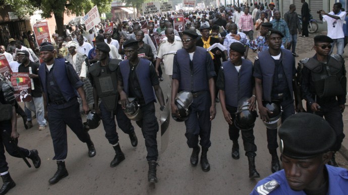 Police provide security as thousands of Malians march in support of foreign military support and intervention to retake Mali's north from Islamist groups, in Bamako, Mali, Thursday, Oct. 11, 2012. (AP Photo/Harouna Traore)