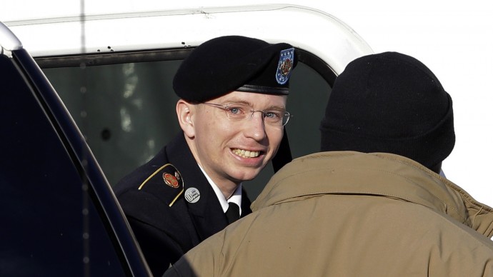 Army Pfc. Bradley Manning, center, steps out of a security vehicle as he is escorted into a courthouse in Fort Meade, Md., Wednesday, Nov. 28, 2012, for a pretrial hearing. (AP Photo/Patrick Semansky)