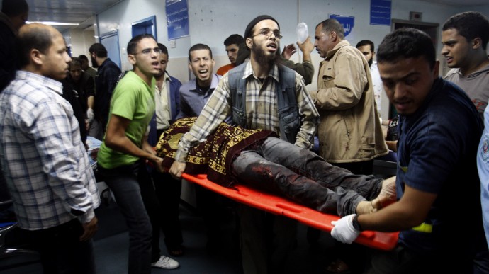 Palestinians bring a wounded man to a hospital in Gaza City, Saturday, Nov. 10, 2012. (AP Photo/Hatem Moussa)
