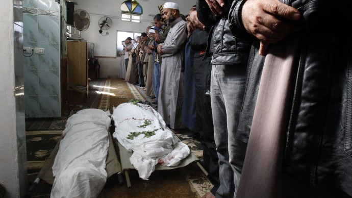 Palestinians pray over the bodies of farmers Amin Bashir, 40, and Tamer Bashir, 30, during their funeral in Deir Al Balah, central Gaza Strip, Monday, Nov. 19, 2012. (AP Photo/Adel Hana)