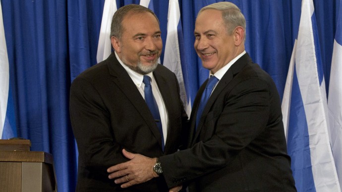 Israeli Prime Minister Benjamin Netanyahu, right, and Foreign Minister Avigdor Lieberman shake hands in front the media after giving a statement in Jerusalem, Thursday, Oct. 25, 2012. (AP Photo/Bernat Armangue)