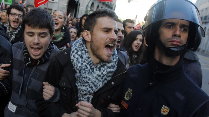 A protestor shout at the police during a general strike in Madrid, Spain, Wednesday, Nov. 14, 2012. Spain's main trade unions stage a general strike, coinciding with similar work stoppages in Portugal and Greece, to protest government-imposed austerity measures and labor reforms. (AP Photo/Andres Kudacki)