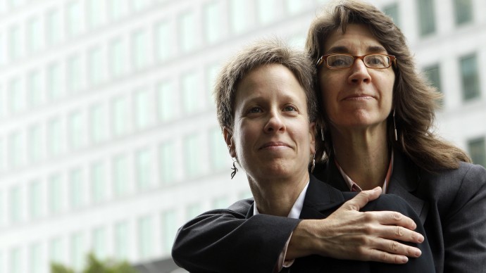 This Dec. 17, 2010 file photo shows Karen Golinski, right, hugging her wife Amy Cunninghis as they pose for a photograph outside of a federal court building in San Francisco. (AP Photo/Jeff Chiu, File)