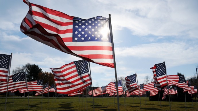American flags wave in the wind in honor of Veterans Day Sunday, Nov. 11, 2012, at Peace Lutheran Church in St. Joseph, Mich. (AP Photo/The Herald-Palladium, Don Campbell)